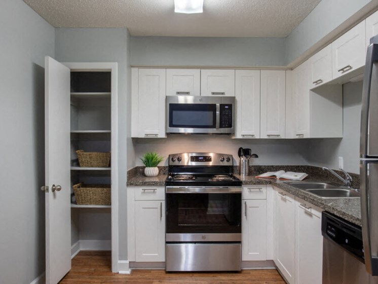 Kitchen with Pantry and Stainless Steel Appliances at Mirabelle Apartments, Alabama, 36608